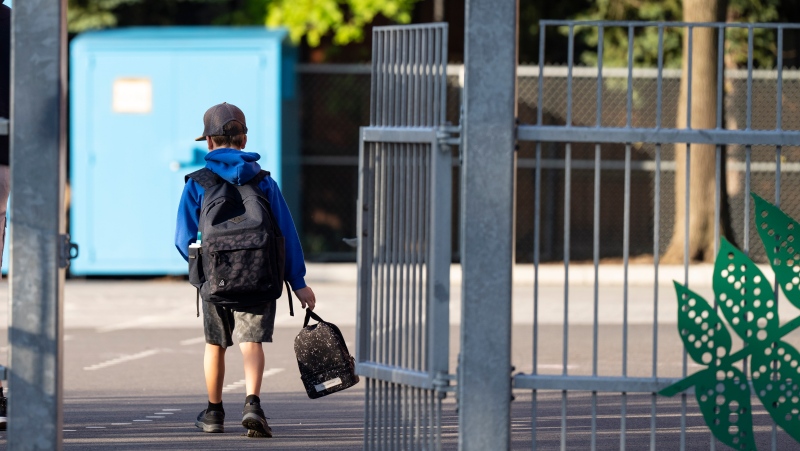 In this file photo, an elementary student arrives for his first day back to school in Montreal, Monday, Aug. 28, 2023. THE CANADIAN PRESS/Christinne Muschi