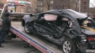 On Monday, Feb. 15, 2010, a tow truck removes the wreckage of a Honda automobile involved a terrible collision with a minivan that had reportedly been trying to flee police.