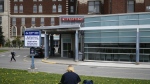 Some eastern Ontario hospitals are bringing back mask requirements in patient-care areas as the respiratory virus season approaches. A person rests on a lawn outside the Emergency Department entrance at the Ottawa Hospital Civic Campus in Ottawa is shown on Monday, May 16, 2022. THE CANADIAN PRESS/Justin Tang
