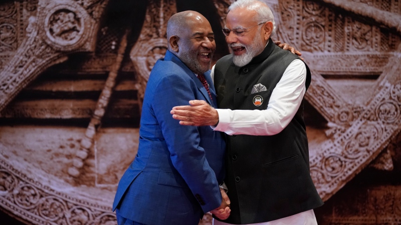 Indian Prime Minister Narendra Modi, right, shares a light moment with African Union Chairman and President of the Union of the Comoros Azali Assoumani upon his arrival at Bharat Mandapam convention centre for the G20 Summit in New Delhi, India, Saturday, Sept. 9, 2023. (AP Photo/Evan Vucci, Pool)
