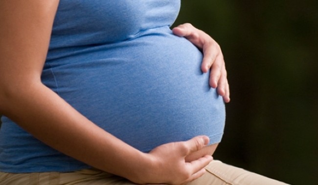 A pregnant woman holding her stomach. (File photo)