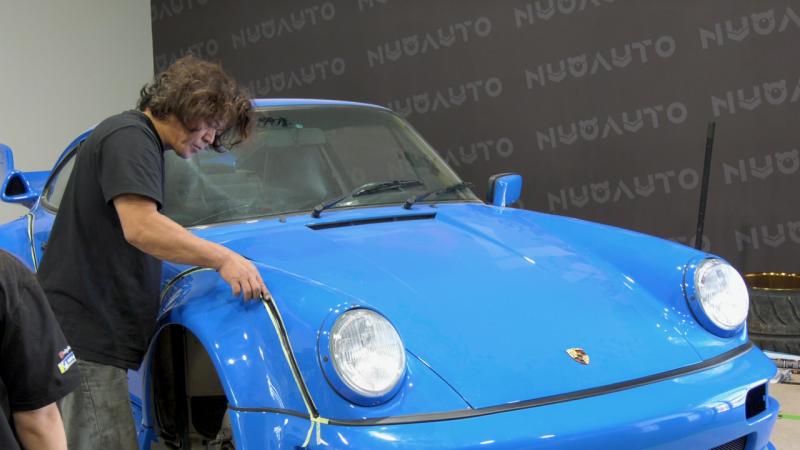 Akira Nakai working on a Porsche with a custom body kit. (Dale Cooper CTV News)