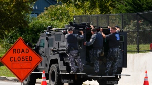 Law enforcement officers ride by a roadblock as the search for escaped convict Danelo Cavalcante continues in Pottstown, Pa., Tuesday, Sept. 12, 2023. (AP Photo/Matt Rourke)