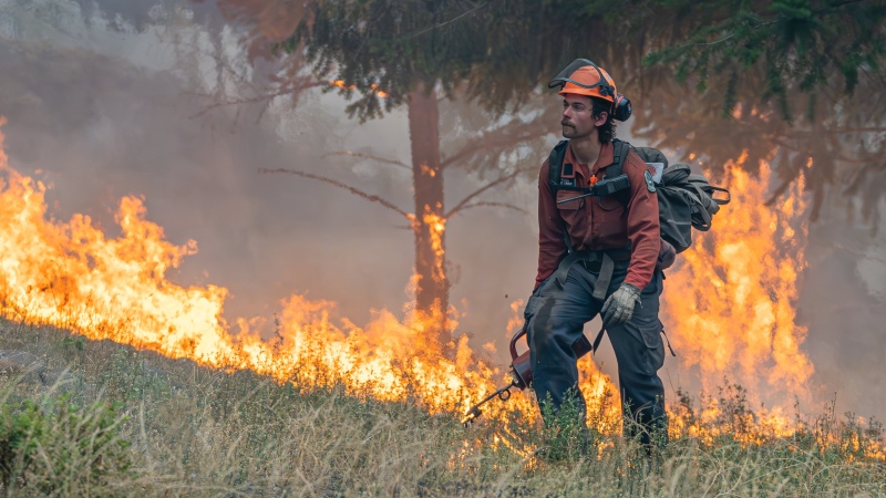 A firefighter performs small hand ignitions on the 2023 McDougall Creek wildfire near West Kelowna. (Image credit: BC Wildfire Service) 