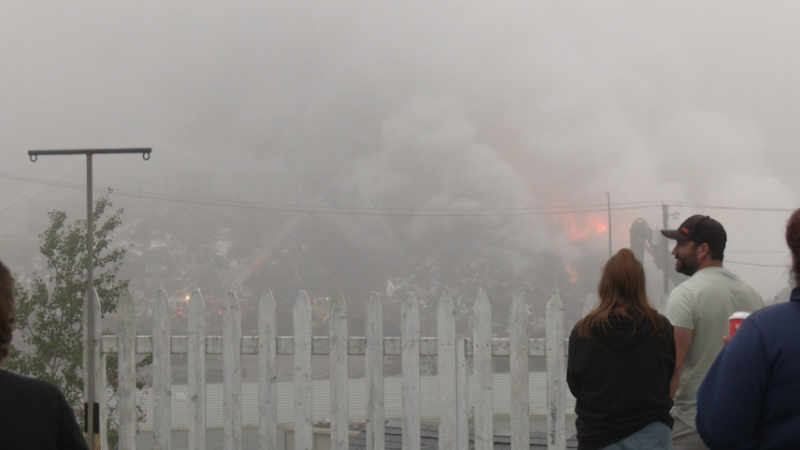 Saint John, N.B., residents watch a fire at the American Iron and Metal recycling facility on Gateway Street on Sept. 14, 2023. (Avery MacRae/CTV Atlantic)