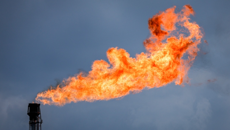 A flare stack burns off excess gas at a processing facility near Crossfield, Alta., Tuesday, June 13, 2023. Most Albertans would support some kind of national cap on carbon emissions from the oil and gas sector, two new polls suggest. THE CANADIAN PRESS/Jeff McIntosh
