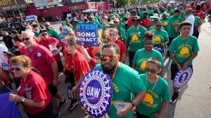 United Auto Workers members walk in the Labour Day parade in Detroit on Sept. 4, 2023. Time is running out to avert a strike that could shut down North America’s unionized auto assembly plants and other manufacturing facilities. (Paul Sancya/AP)