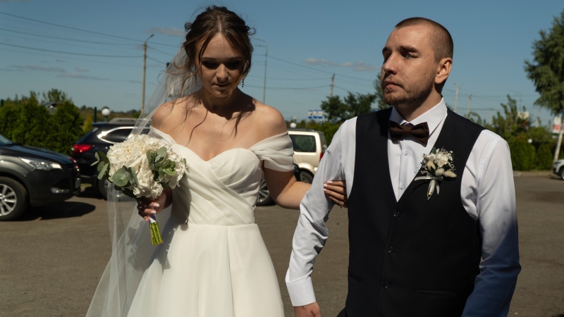 Bride Vladislava Ryabets, left, helps groom Ivan Soroka, right, to walk during their wedding day in Kyiv, Ukraine on Saturday, Sept. 9, 2023. Shrapnel blinded Soroka permanently on Aug. 2, 2022 when Russian mortar fire struck his retreating unit near Bakhmut during the war's longest and bloodiest battle. Despite Soroka's injury the couple has been determined to move forward. (AP Photo/Bela Szandelszky)