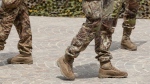 Soldiers in camouflage pants are seen in a Shutterstock image. 