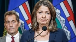 Alberta Premier Danielle Smith, right, becomes emotional as she speaks to the media about an E. coli outbreak at several Calgary daycares as Dr. Mark Joffe, Alberta chief medical officer of health, looks on in Calgary, Alta., Friday, Sept. 15, 2023. THE CANADIAN PRESS/Jeff McIntosh