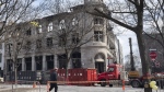 A lawsuit has been filed by the owner of an Old Montreal building where seven people perished in a fire last March. The search continues Monday, March 27, 2023, at the scene of a fire in a heritage building in Old Montreal. THE CANADIAN PRESS/Ryan Remiorz