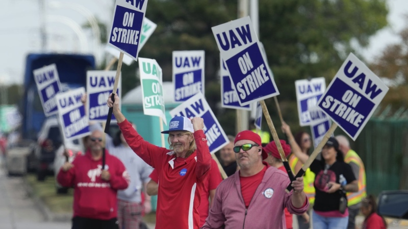 United Auto Workers members walk a picket line during a strike at the Ford Motor Company Michigan Assembly Plant in Wayne, Mich., Friday, Sept. 15, 2023. (AP Photo/Paul Sancya, File)
