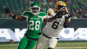 Edmonton Elks defensive lineman A.C. Leonard (6) catches the football for a touchdown as Saskatchewan Roughriders defensive back Trumaine Washington (28) looks on during the first half of CFL football action in Regina, on Friday, September 15, 2023. THE CANADIAN PRESS/Heywood Yu