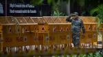 An Indian paramilitary soldier stands guard next to a police barricade outside the Canadian High Commission in New Delhi, India, Tuesday, Sept. 19, 2023. (AP Photo/Altaf Qadri)