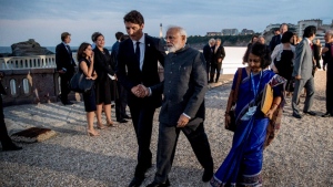 Canadian Prime Minister Justin Trudeau, center left, and Indian Prime Minister Narendra Modi, center right, walk together following the G-7 family photo with guests at G-7 summit at the Hotel du Palais in Biarritz, France, Sunday, Aug. 25, 2019. (AP Photo/Andrew Harnik)