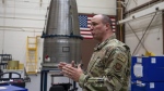 In this image provided by the U.S. Air Force, Chief Master Sgt. Andrew Zahm speaks in front of the top of a Minuteman III intercontinental ballistic missle shroud at F.E. Warren Air Force Base, Wyo., Aug. 16, 2023. (Senior Airman Sarah Post/U.S. Air Force via AP)