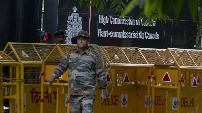An Indian paramilitary soldier stands guard next to a police barricade outside the Canadian High Commission in New Delhi, India, Tuesday, Sept. 19, 2023. (AP Photo/Altaf Qadri)