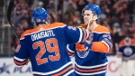 Connor McDavid and Leon Draisaitl celebrate a goal against the Arizona Coyotes during overtime NHL action in Edmonton on Wednesday March 22, 2023.THE CANADIAN PRESS/Jason Franson