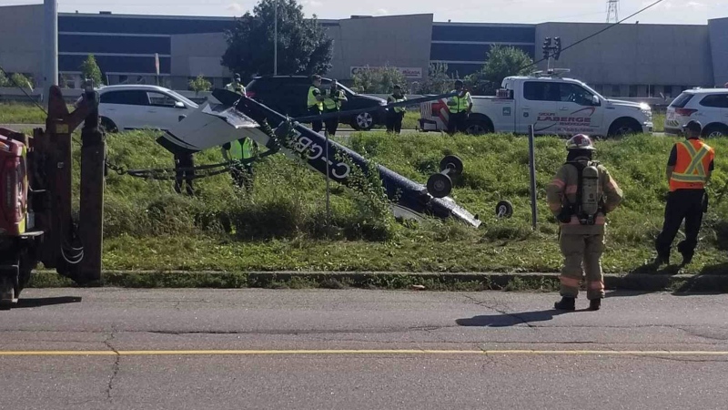 A small plane is upside down on the side of Highway 20 in Boucherville, on Montreal's South Shore, on Wednesday, Sept. 20, 2023. (Source: Martin Dufresne)