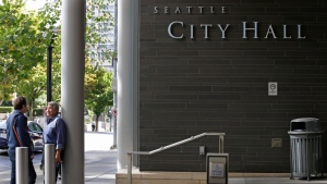 FILE - An entrance to Seattle City Hall is shown, Tuesday, Sept. 12, 2017, in downtown Seattle. (AP Photo/Ted S. Warren, File)