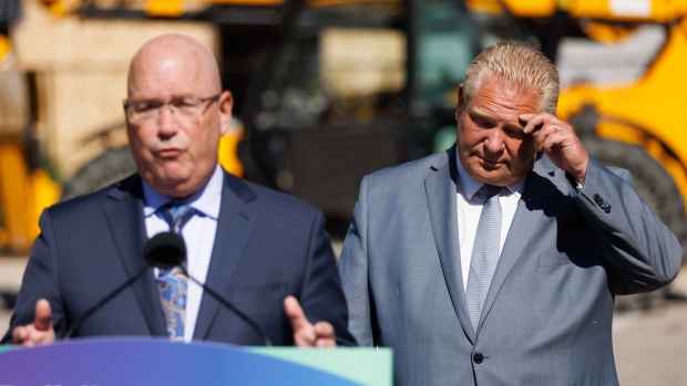 Ontario Premier Doug Ford listens as Ontario’s minister of housing Steve Clark speaks during a press conference in Mississauga, Ont., Friday, Aug. 11, 2023. THE CANADIAN PRESS/Cole Burston