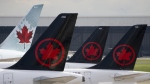 Canada's biggest airline says an unauthorized group briefly breached an internal system linked to the personal information and records of some employees. Air Canada logos are seen on the tails of planes at the airport in Montreal, Que., Monday, June 26, 2023. THE CANADIAN PRESS/Adrian Wyld
