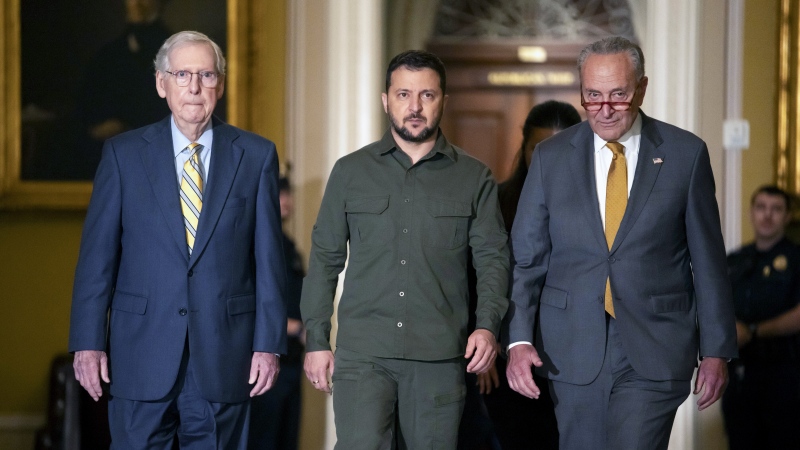 Ukrainian President Volodymyr Zelenskyy, centre, walks with Sen. Mitch McConnell, R-Ky., left, and Sen. Chuck Schumer, D-N.Y., right, at Capitol Hill on Thursday, Sept. 21, 2023, in Washington. (AP Photo/Mark Schiefelbein)