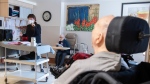 A woman sings for residents at Idola Saint-Jean long-term care home in Laval, Que., Friday, February 25, 2022. THE CANADIAN PRESS/Graham Hughes