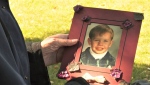 Tristan Anderson, 28, was stabbed to death on Saturday, Sept. 16 in what police believe was a targeted attack. In this photo, his mother Heather holds a photo of Tristan as a child. 