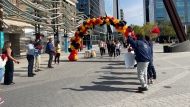 Walkers cross the finish line at the 2023 Walk a Mile in Her Shoes event at Pat Fiacco plaza. (Hallee Mandryk/CTV News)