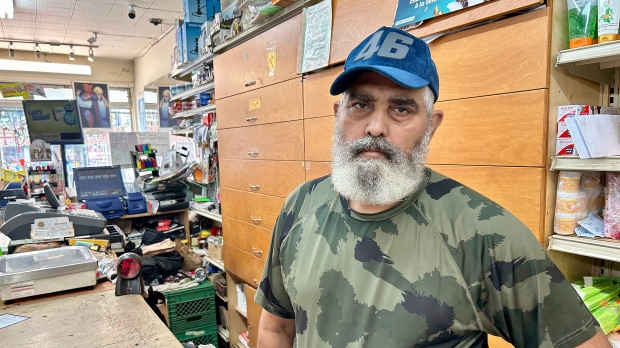 Montrealer Sukhwinder Dhillon says he was planning to visit his birthplace in India's Punjab state to see family and sort out affairs with his deceased father's estate, but has now put the trip on hold. Dhillon is seen in his shop in Montreal, Thursday, Sept. 21, 2023. The 56-year-old grocery store owner, who came to Canada in 1998, says he makes the trip every two or three years, and hopes the visa halt will be short-lived. THE CANADIAN PRESS/Christopher Reynolds