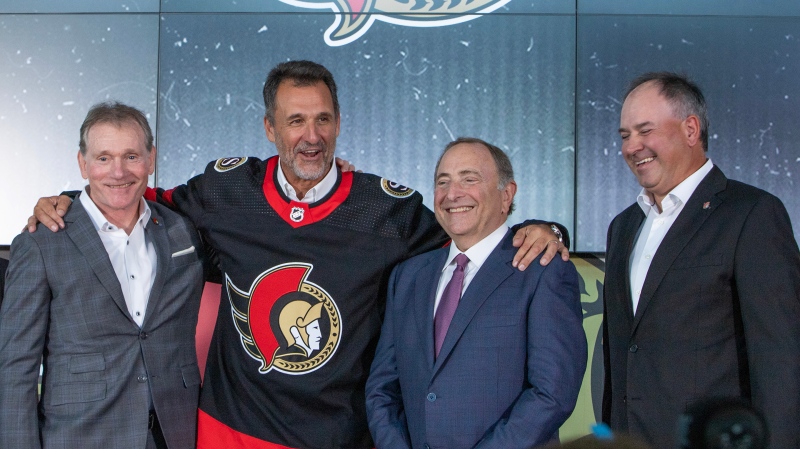 Ottawa Senators NHL hockey team owner Michael Andlauer, centre left, CEO Cyril Leeder, left, NHL Commissioner Gary Bettman and Senators General Manger Pierre Dorion, right, smile during a press conference in Ottawa on Friday September 22, 2023. The NHL announced Thursday that the transfer of the club to a group led by Michael Andlauer has been unanimously approved by the league's board of governors, and that the transaction has been completed. (Fred Chartrand/THE CANADIAN PRESS) 