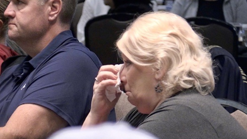 An audience members wipes away tears while listening to speakers at the 15th annual Addiction Recovery Breakfast in London, Ont. on Sept. 22, 2023. (Sean Irvine/CTV News London)