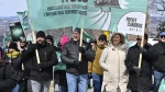 Union leaders Eric Gingras, left to right, CSQ, Robert Comeau, APTS, Magali Picard, FTQ and François Énault, CSN march in a common front on Thursday, March 30, 2023 in front of the legislature in Quebec City. THE CANADIAN PRESS/Jacques Boissinot