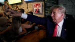 Former President Donald Trump greets supporters at the Treehouse Pub & Eatery, Wednesday, Sept. 20, 2023, in Bettendorf, Iowa. (AP Photo/Charlie Neibergall)