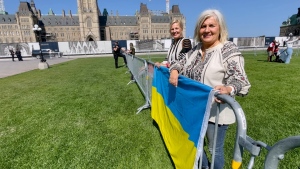 Sisters Oresta and Laryssa Korbutiak fly their Ukrainian flag on Parliament Hill. (Dave Charbonneau/CTV News Ottawa)