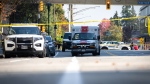 An ambulance is seen on Glen Drive after a shooting involving two RCMP officers in Coquitlam B.C. on Friday, September 22, 2023. At least two RCMP officers have been injured in what is being described as a critical incident in the Metro Vancouver city of Coquitlam. THE CANADIAN PRESS/Ethan Cairns