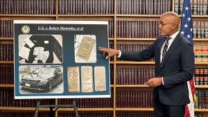 Damian Williams, U.S. Attorney for the Southern District of New York, talks about a display of photos of evidence in an indictment against Sen. Bob Menendez during a news conference, Friday, Sept. 22, 2023, in New York. (AP Photo/Robert Bumsted)