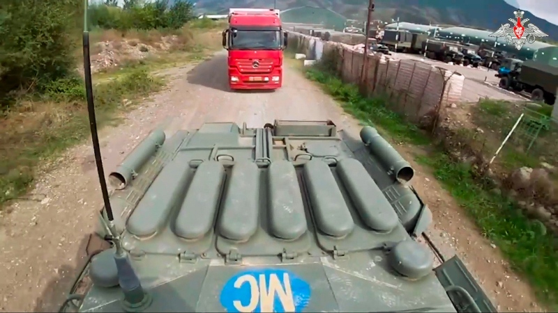 In this image made from video released by the Russian Defence Ministry Press Service, Sept. 23, 2023, an armoured personnel carrier of the Russian peacekeeping contingent accompanies the delivery of humanitarian aid to Nagorno-Karabakh, which has been cut off from supplies since late last year. (Russian Defence Ministry Press Service via AP)