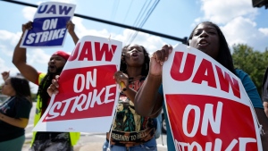 United Auto Workers of local 868 demonstrate to passing vehicles near a Stellantis parts-distribution centre, Friday, Sept. 22, 2023, in Morrow, Ga. (AP Photo/Mike Stewart)
