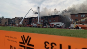 Police tape cordons off the site of a major fire at two Dorval, Que. apartment buildings. Dozens of people were evacuated Saturday afternoon. (Angela MacKenzie, CTV News)  