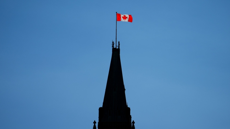 The Canada flag on the Peace Tower is lit up by morning light on Parliament Hill in Ottawa, May 9, 2023. THE CANADIAN PRESS/Sean Kilpatrick