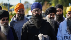 Moninder Singh, centre, a spokesperson for the British Columbia Gurdwaras Council, speaks to reporters outside the Guru Nanak Sikh Gurdwara Sahib in Surrey, B.C., on Monday, September 18, 2023, where temple president Hardeep Singh Nijjar was gunned down in his vehicle while leaving the parking lot in June. THE CANADIAN PRESS/Darryl Dyck