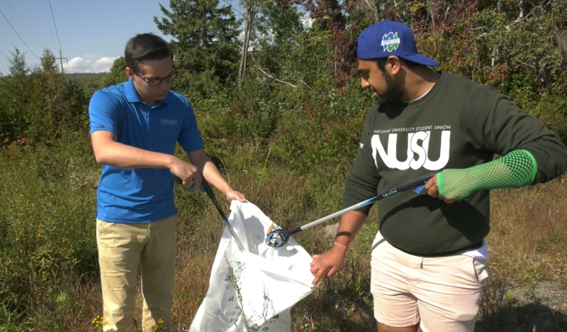 Nipissing University criminal justice students, Preston English and Harikesh Panchal are cleaning up their North Bay neighborhood one piece of trash at a time. (Eric Taschner/CTV News Northern Ontario)