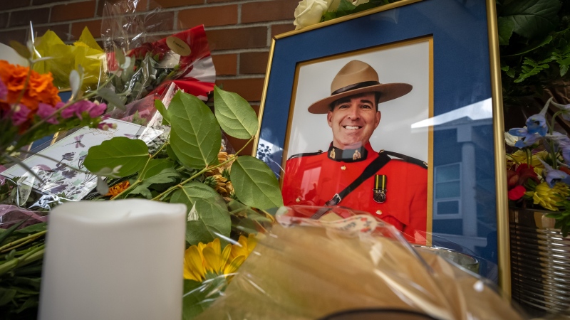 A memorial full of flowers is set up for officer Rick O’Brien, in front of the Ridge Meadows detachment in Maple Ridge B.C., on Saturday, September 23, 2023. O’Brien lost his life during duty in Coquitlam the day before. (THE CANADIAN PRESS/Ethan Cairns)
