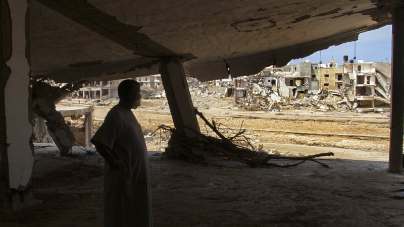 Derna flood survivor Abdul Salam Anwisi looks at the destroyed homes following flooding caused by Mediterranean storm Daniel, in Derna, Libya, Sunday, Sept. 17, 2023. (AP Photo/Yousef Murad)
