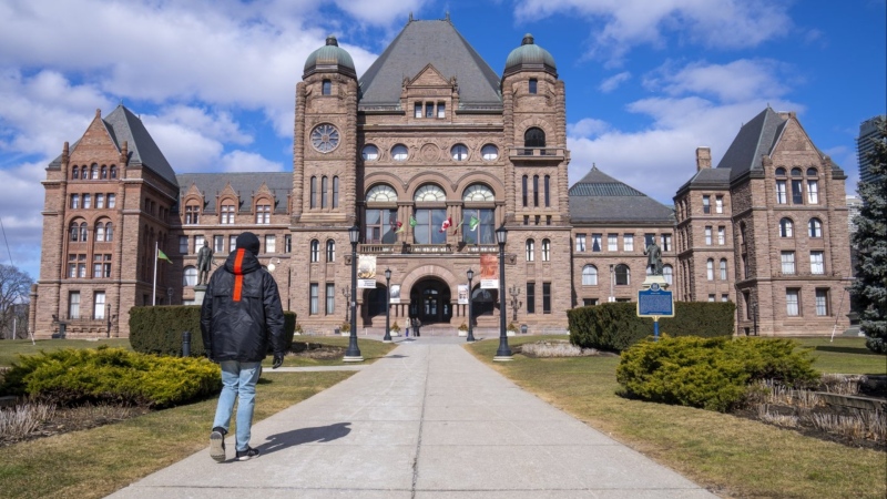 A man walks in front of Queen’s Park in Toronto, Monday, Feb. 20, 2023. Ontario provincial politicians are heading back to the legislature today after its summer break that saw a whirlwind few weeks of developments in the Greenbelt controversy. THE CANADIAN PRESS/Frank Gunn