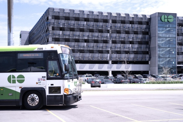 A bus is seen outside the parking lot at the Bramalea GO Station, in Brampton, on Thursday May 11, 2023. Ontario's minister of infrastructure is proposing a new way of funding GO Transit stations that she says will both increase transit service and housing nearby. THE CANADIAN PRESS/Chris Young