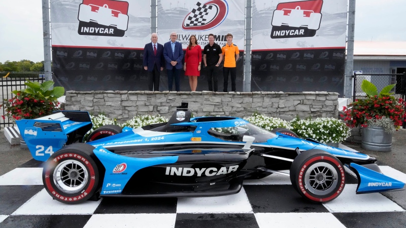 Roger Penske, from left, Chairman of Penske Corporation, Wisconsin Gov. Tony Evers, Shari Black, State Fair Park CEO,  6-time IndyCar Champion Scott Dixon, second-year NTT IndyCar Series driver David Malukas stand in Victory Circle before a press conference announcing the return of IndyCar auto racing at Milwaukee Mile, Monday, Sept. 25, 2023, in West Allis on. IndyCar announced its schedule Monday morning, including a doubleheader on Labor Day weekend that gives the 120-year-old track at State Fair Park new life yet again. (Mike De Sisti/Milwaukee Journal-Sentinel via AP)