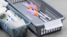 A basket of needles containing Pfizer-BioNtech COVID-19 vaccine waits to be administered to patients at a COVID-19 clinic in Ottawa on March 30, 2021. THE CANADIAN PRESS/Sean Kilpatrick
